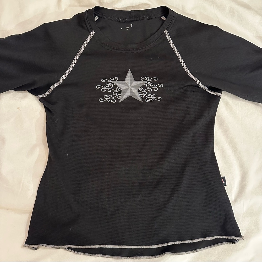 grey star with swirly pattern around it 
black tee